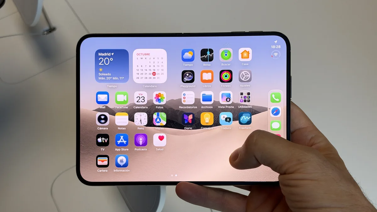 Opened iPhone Duo held in one hand in an Apple Store, showing its wide inner display.